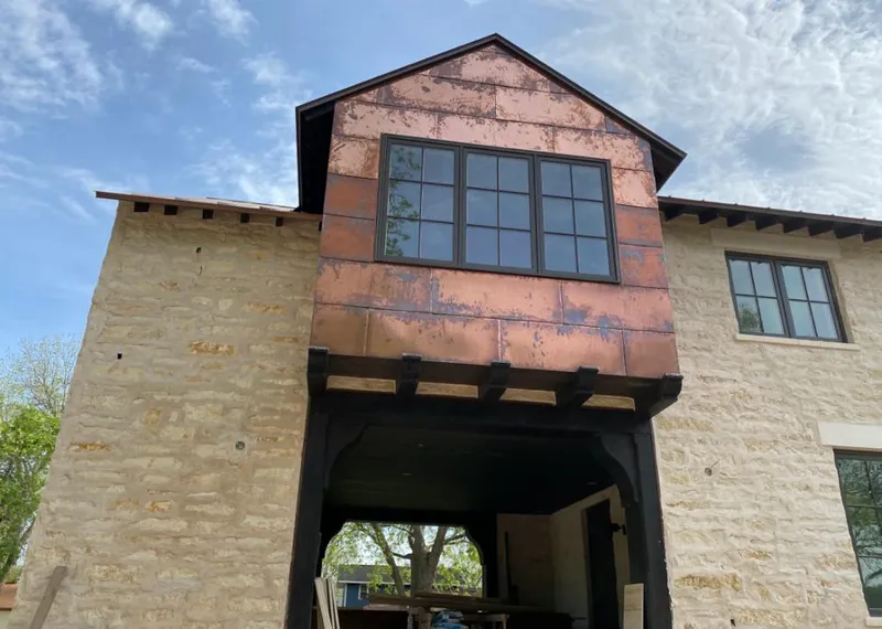 Copper metal panel facade on a stone building for Metal Roof Coating in Bloomington
