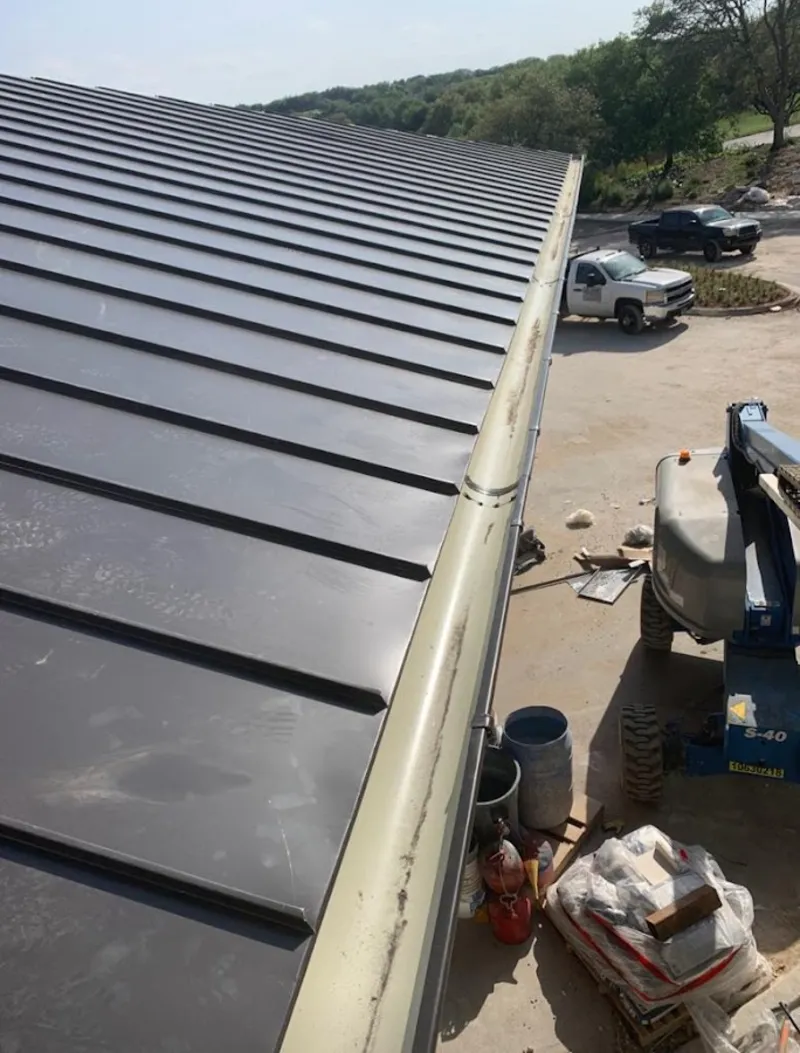 Standing seam panel and gutter detail on a metal roofing jobsite in Bloomington